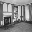 Interior. View of first floor South room/ drawing room from North showing fireplace flanked by giant fluted pilasters, panelling and windows