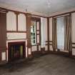 Interior. View of first floor South room/ drawing room from North showing fireplace flanked by giant fluted pilasters, panelling and windows