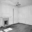 Interior. View of first floor North room/principal bedroom from South showing panelling and fireplace