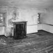 Interior. View of second floor North room from South showing coombed ceiling and fireplace