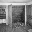 Interior. View of second floor East room/housekeepers room from North fitted cupboards open.