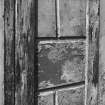 Detail of tmber panelling on porch designed to look like ashlar stonework