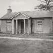 View of Bruxie Lodge in derelict condition, showing Doric portico