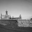 View of old parish church in foreground and new church behind from SW