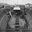 General view into North Harbour dry dock, Peterhead, showing boat undergoing repairs.