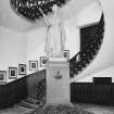 Interior.Town-house, ground floor, main stair hall, view of stair with statue of Queen victoria.