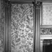 Interior.
Detail of foliate wallpaper and raised decorative pilasters on staircase landing.
