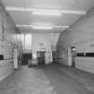 Interior.  View of main entrance hall from W showing stairs to 2nd floor and service lift.