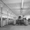 Interior.  View of ground floor from SE with spinning looms on left.