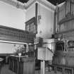 Interior. View of platform from N showing communion table and pulpit