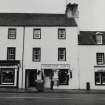 Inveraray, Main Street East, house.
View of house on West side with signage, 'Highland Arts' and 'The Paddle Wheel'.