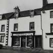 Inveraray, Main Street East, house.
View of house on West side with signage 'Newsagent'.