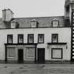Inveraray, Main Street North, house.
General view of house with first floor shop window, 'Dewars Boot stores'.