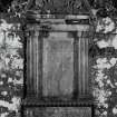 Inveraray, Kilmalieu Burial Ground.
View of the mural monument of James Campbell of Stonefield, 1731. Curved pediment with two putti and an armorial panel, resting on ionic pilasters.