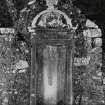 Inveraray, Kilmalieu Burial Ground.
View of the mural monument of Colin Campbell of Braglenmore, 1736. Corinthian demi-columns framing an inscription topped with a curved pediment containing an armorial panel. The monument is topped with a flaming urn.