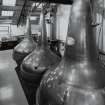 Bowmore Distillery
Interior view within still house showing three of the four copper pot stills, all of which are heated by steam coils