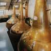 Bowmore Distillery
Interior view within still house showing three of the four copper pot stills, all of which are heated by steam coils