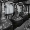 Bowmore Distillery
Interior view within still house showing the four copper pot stills, all of which are heated by steam coils