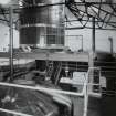 Bowmore Distillery
Interior view within mash house showing mash tun (below), grist hopper (above), and copper water tanks in background