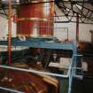 Bowmore Distillery
Interior view within mash house showing mash tun (below), grist hopper (above), and copper water tanks in background