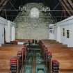 Interior. View from E showing boarded walls and pews from the vhurch on The Oa