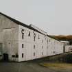 Islay, Caol Ila Distillery.
View of distillery from SSE, with bonded warehouse occupying the S end of the distillery complex in the foreground