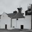 Laphroaig Distillery
View from N of the two kilns at the W end of the floor maltings, the nearer of the two being in operation, resulting in peat smoke emerging from the louvres of the ventilator