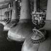 Laphroaig Distillery
Detailed view interior view from E within Still House, showing the three wash stills in the foreground, and four Low Wines and Feints stills in the background.  All seven stills are heated by steam coils