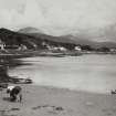 Jura, Craighouse, general.
General view from South with two people and a puppy on the beach.