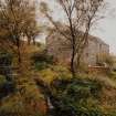 Jura, Craighouse, Grain Mill
View from SW of SW gable (showing iron remains of water-wheel hub) and SE side of mill building, with remains of the lade also partly visible