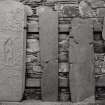 Keills Old Parish Church, interior, gravestones.
General view of stones on North wall.

