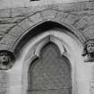 Detail of carved heads and window on South gable.