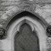 Detail of carved heads and window on South gable.