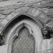 Detail of carved heads and window on South gable.