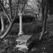 Detail pf classical column and table tomb near the bird bath