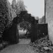 Detail of archway and gate between house and stable block