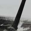 View of chimney being demolished.
