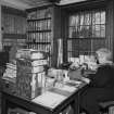 Interior. Hone Works office, general view, with the secretary, Mrs McLellan, at her desk