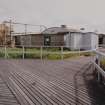 View from N of wooden gangways and N side of DL3 (Detonator Filling Building)