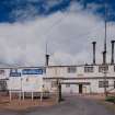 General exterior view of DD1 (Chemical Plant), with warning signs in foreground