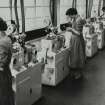 Interior. Detonator Department: view of automatic fusehead comb-soldering machines, copied from 'Ardeer Factory', a softback book published by ICI Nobel Division published in about 1960