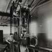 Photographic copy of Interior view showing Cordite machine - large screw press pressing size 50 cordite