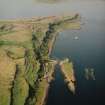 Oblique aerial view of Little Cumbrae Island centred on the tower-house and township, taken from the S.