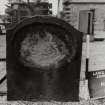 View of flat top headstone with slightly curved central feature  and central horizontal oval. Inscription illegible.
Largs Parish Churchyard no 227
