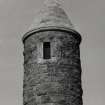 Detail of top part of tower showing window opening and and conical roof