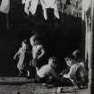 Glasgow, General street scenes.
View of children playing under a washing line.