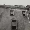 Glasgow, Castlemilk House.
Detail of upper storeys and parapet of Tower House from South-East.