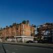 General view of tenements from ESE showing gateway to former meat market and  411 Gallowgate (former Bank of Scotland) to right
