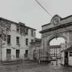 View of courtyard buildings and 'clock' entrance arch from NW