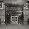Glasgow, 52 Langside Drive, interior.
General view of ground floor reception room, fireplace. Design in green tiles with central green man and two winged sea-horses.
